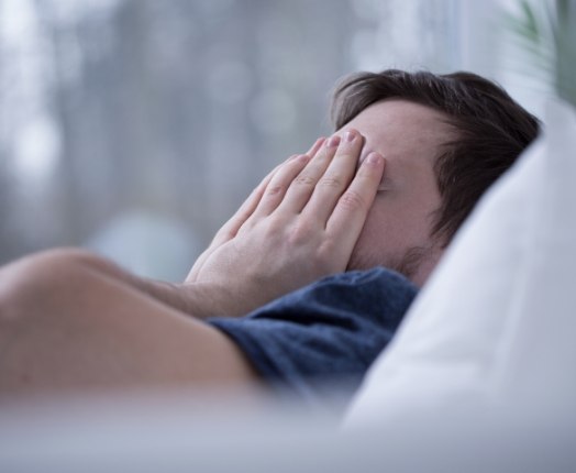 Person waking feeling tired due to obstructive sleep apnea