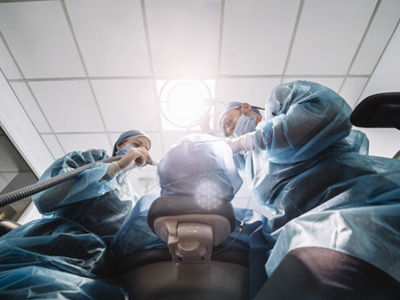 Dentists performing a dental implant surgery
