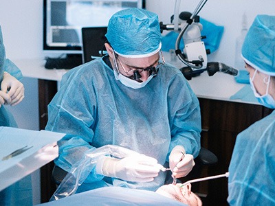 Dentists performing a dental implant surgery