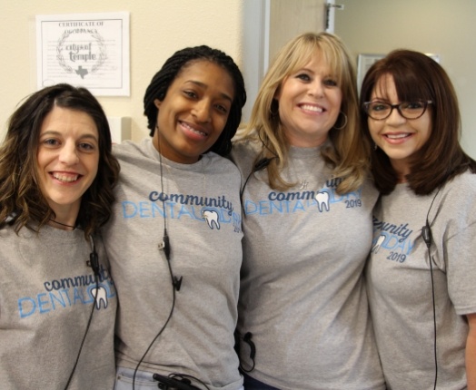 Four friendly dental team members