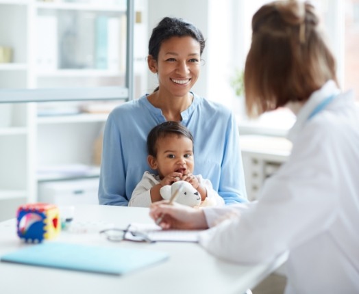 Happy mother and child smiling a dentist