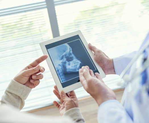 Dentist discussing patient during preventive dentistry checkup and teeth cleaning visit