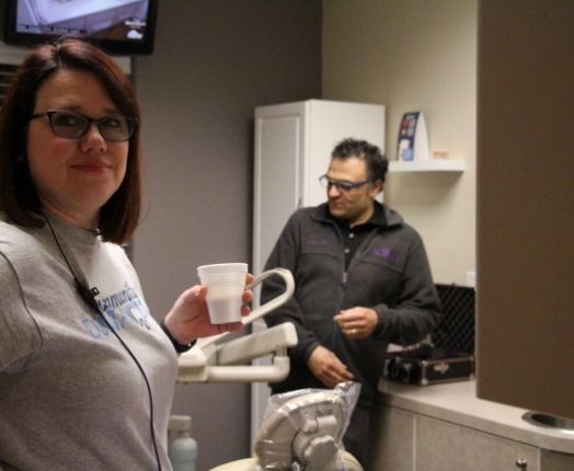 Dentist and dental team member in dental office treatment room