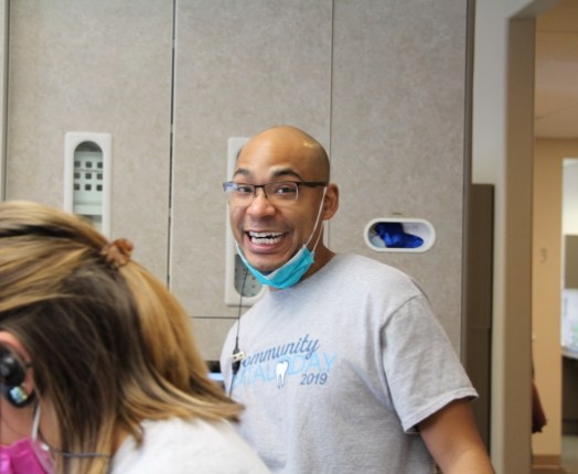 Dental team member laughing in dental office