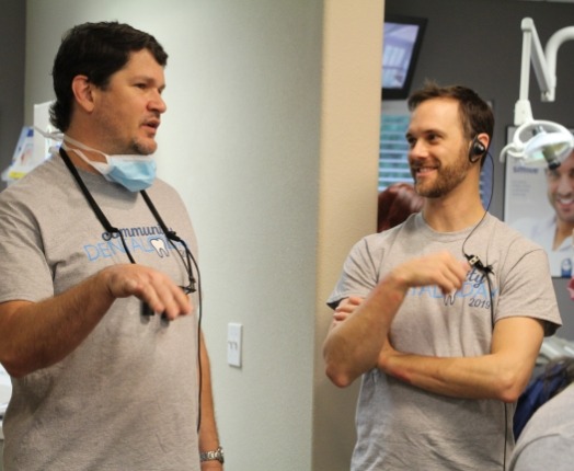 Two dental team members discussing dental patient treatment options