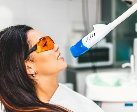 Woman receiving teeth whitening treatment