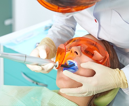 A woman receiving a dental filling