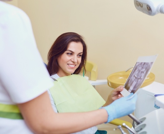 Dentist and patient discussing the cost of dental implants