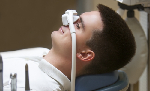 Man receiving nitrous oxide sedation dentistry treatment