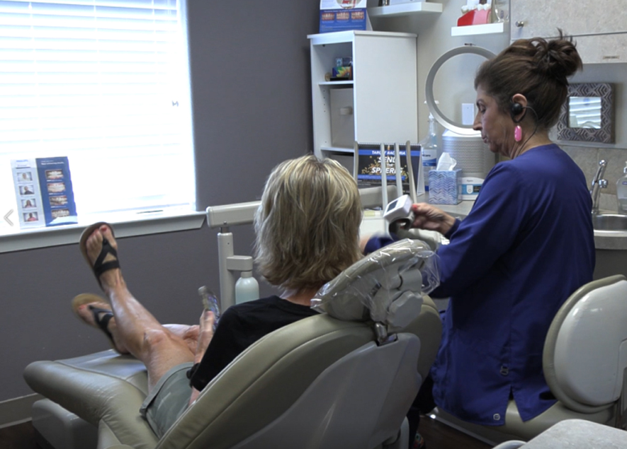Dentist and dental patient discussing dental implants