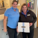 Dental team member and patient smiling together