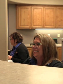 Dental team members behind reception desk