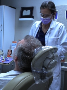 Dentist treating dentistry patient in dental treatment room