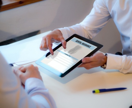 Dental team member reviewing dental insurance forms