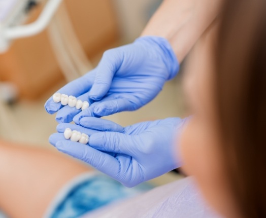 Dentist showing patient two dental bridge options