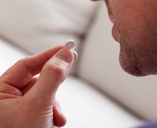 Person taking oral conscious dental sedation pill