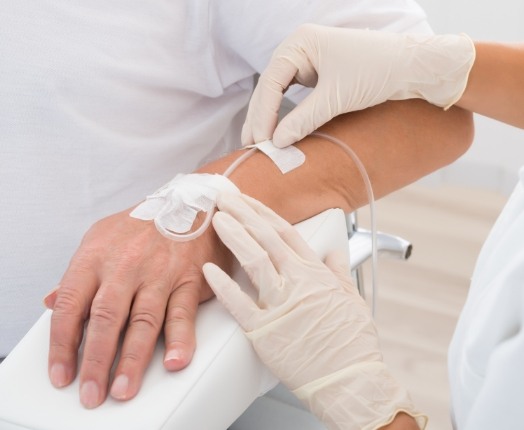 Dental patient receiving intravenous sedation dentistry