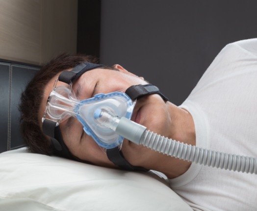 Person with CPAP system sleeping