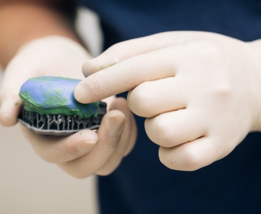 Dentist crafting a wax up model