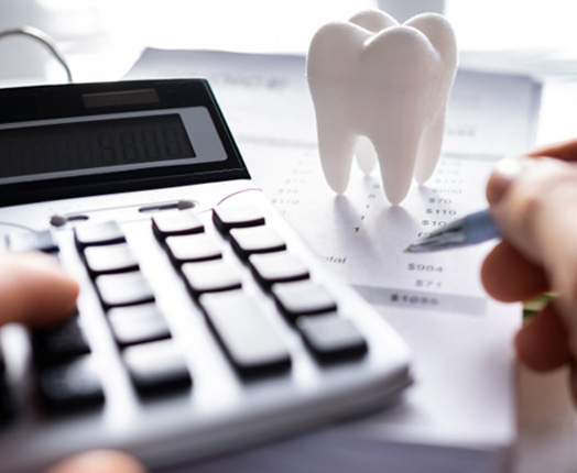A patient calculating the cost of their dental care