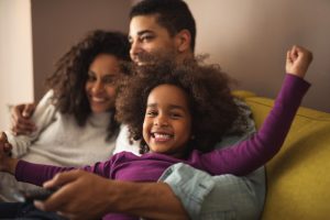 family embracing on the couch