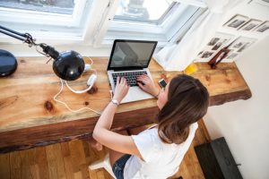 A woman working on a laptop computer.