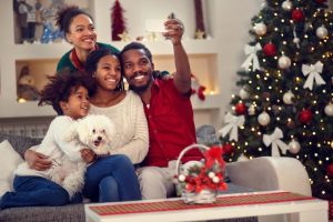 family smiling hugging holiday selfie