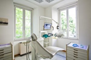 Temple dentist office and dental chair prepared for patient in COVID-19