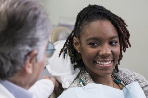 woman listening to dentist in Temple