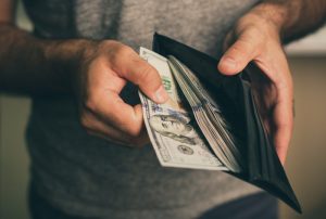 person holding wallet of money