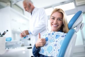 Woman smiling during her dental visit because she’s saving money