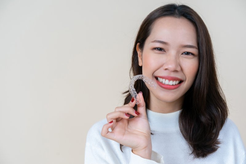 person holding an Invisalign tray