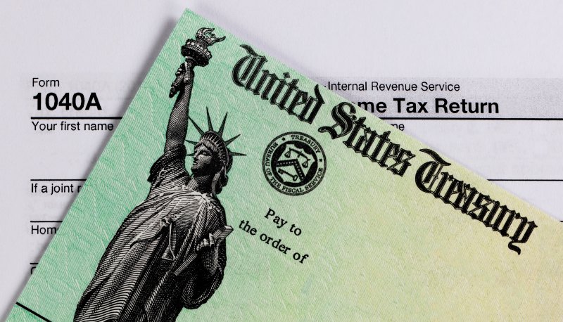 A closeup view of a refund check and tax form