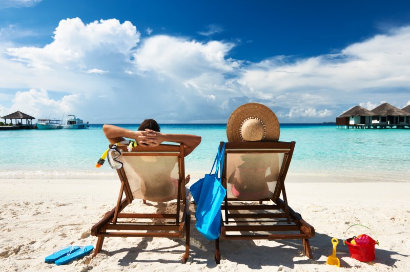 A couple lounging on the beach for summer vacation