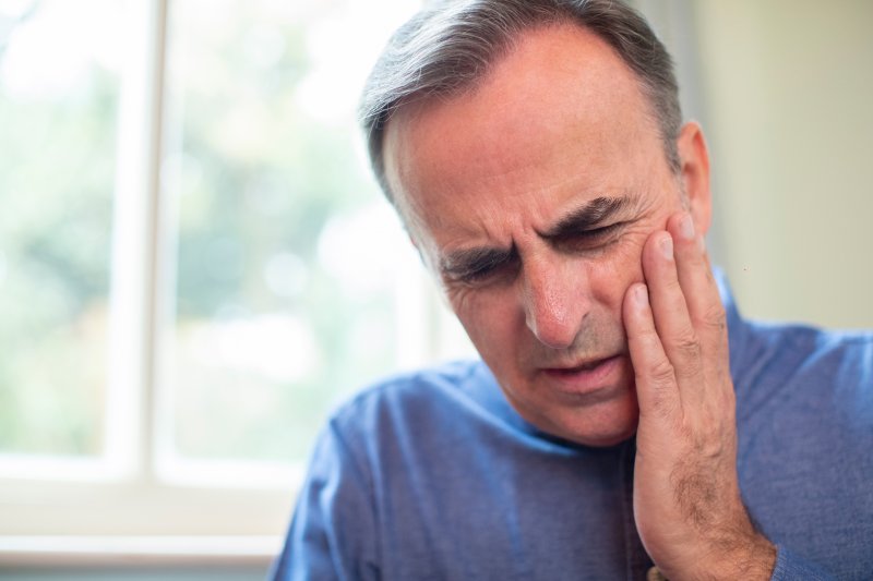 An older man facing a dental emergency