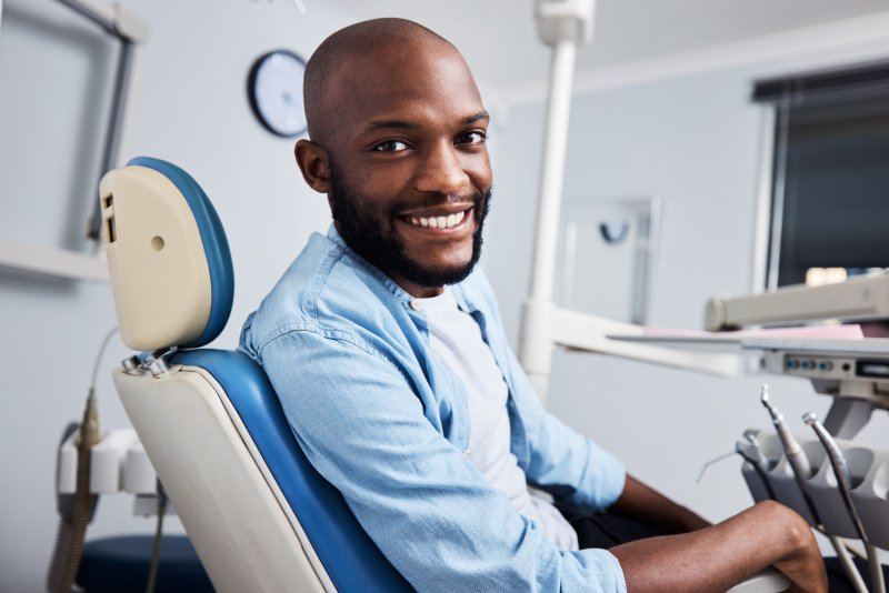 A young man smiling while in a dentist’s officer