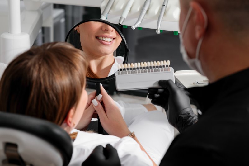 A dentist preparing his patient for a smile makeover